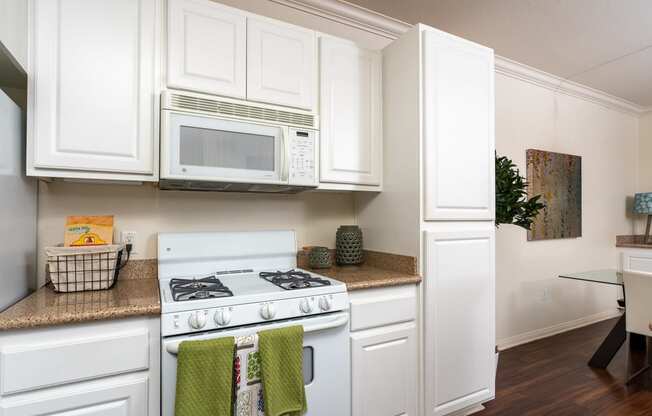 Apartments for Rent in Rancho Cucamonga, CA - Barrington Place Kitchen With White Appliances, and Modern Wood Cabinets