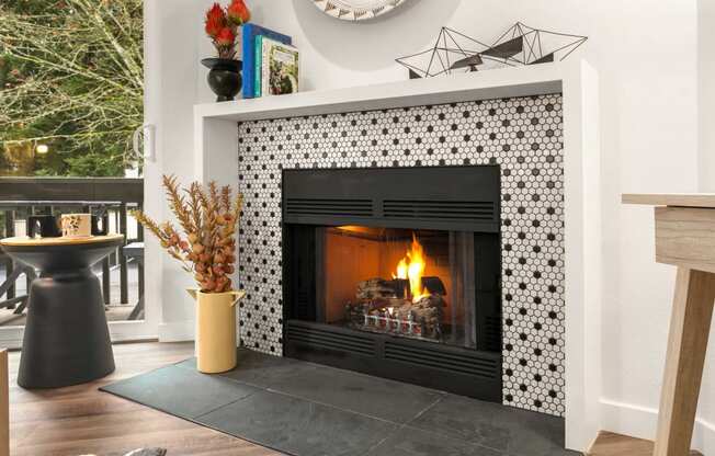 the fireplace in the living room is decorated with black and white tiles