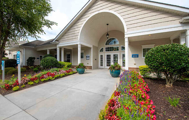 A building with a white facade and a large arched entrance.