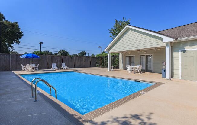 a house with a pool in front of a building