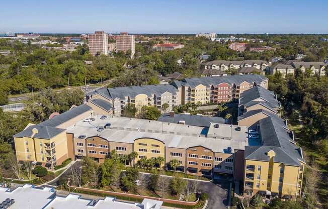 an aerial view of a building with a city in the background