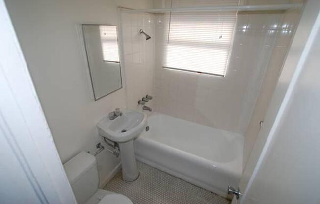 a white tub sitting next to a sink