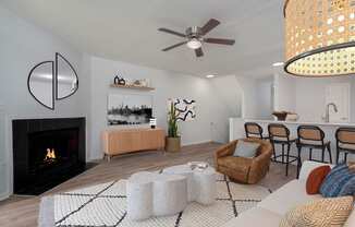 a living room with a fireplace and a table with chairs