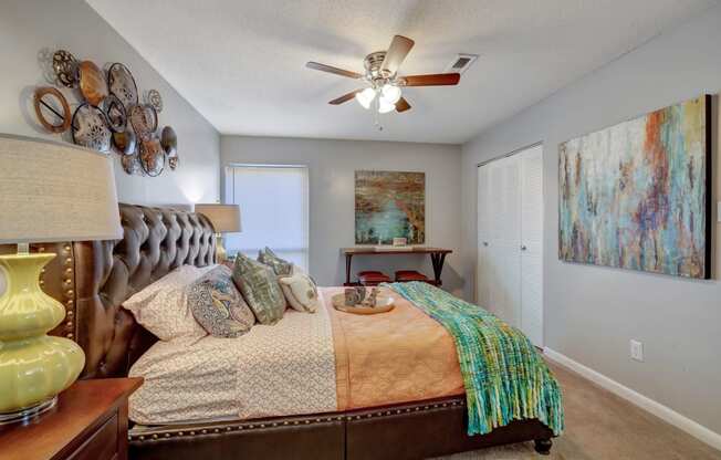 a bedroom with a bed and a ceiling fan