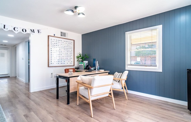 a dining room with a table and chairs and a window