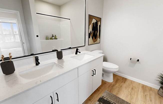 A bathroom with a white sink and toilet.