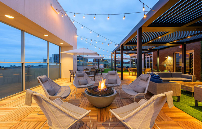 a patio with chairs and a fire pit
