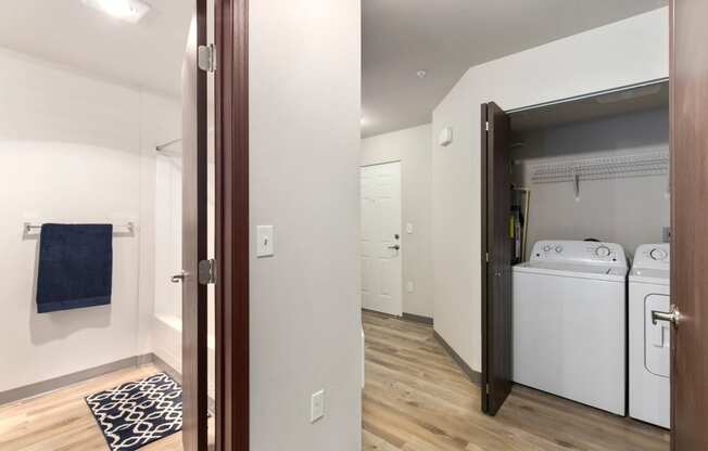 Pioneer Meadows Washer and Dryer Closet and View into Bathroom