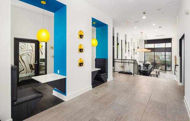 the lobby of a building with blue and white walls and yellow lights