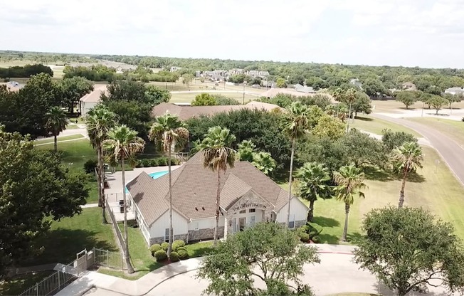 A house with a pool surrounded by trees.