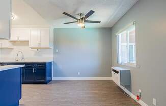 A kitchen with blue cabinets and a white countertop.