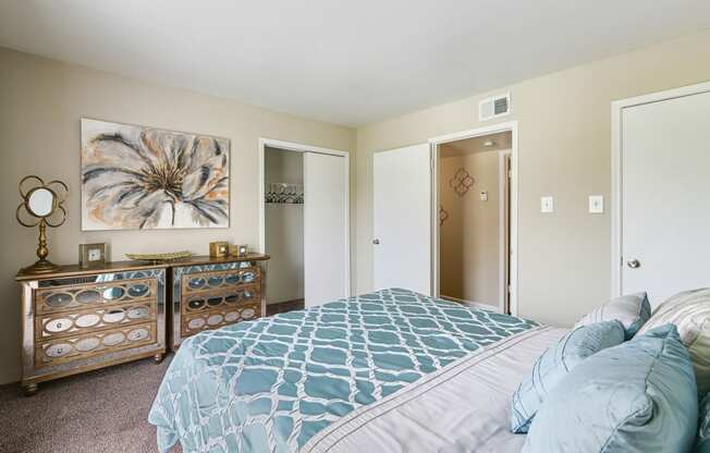 a bedroom with a large bed and a dresser