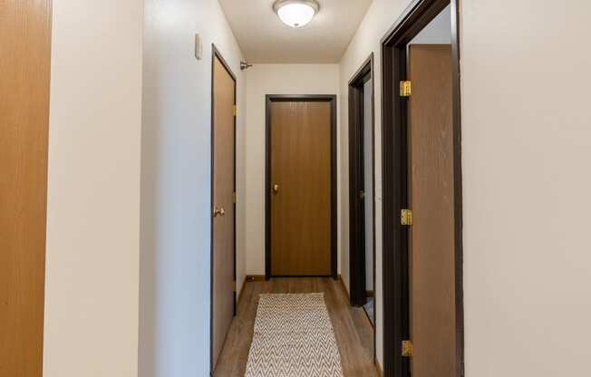 Fargo, ND Parkside Apartments. A corridor with two doors and a carpeted floor