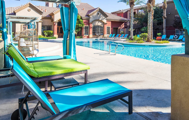 A poolside area with sun loungers and a pool.