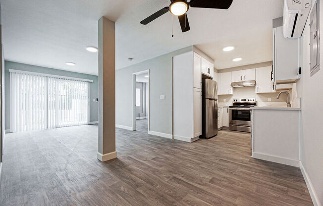 an open kitchen and living room with a ceiling fan at Citra Apartments LLC, San Diego, California