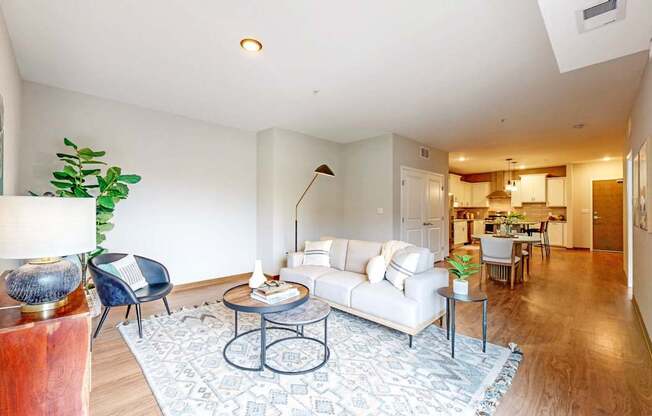A living room with a white couch and a coffee table.