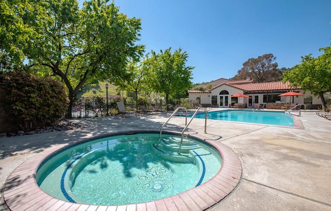 A round pool with a hot tub in the middle.