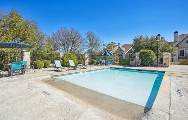 Kiddie pool with lounge chairs at On the Green apartments in Austin, TX