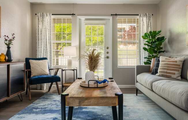 a living room with a couch chair and coffee table at Odyssey Apartments, Albuquerque, NM