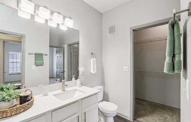 A bathroom with a white sink and toilet.