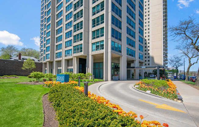 A tall building with a blue sign in front of it.