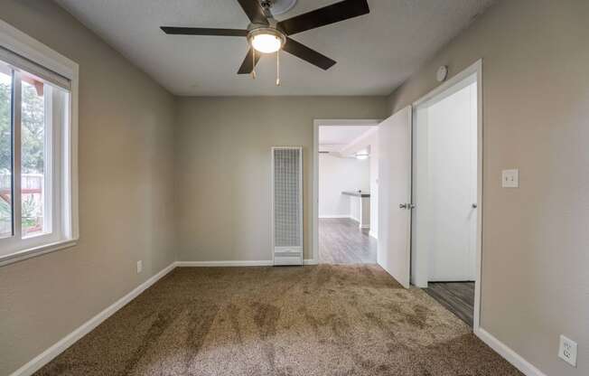 a bedroom with a ceiling fan and a closet