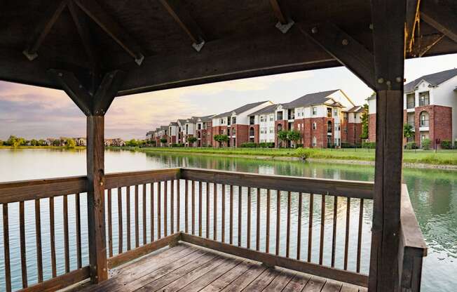 a view of a lake with an apartment complex in the background