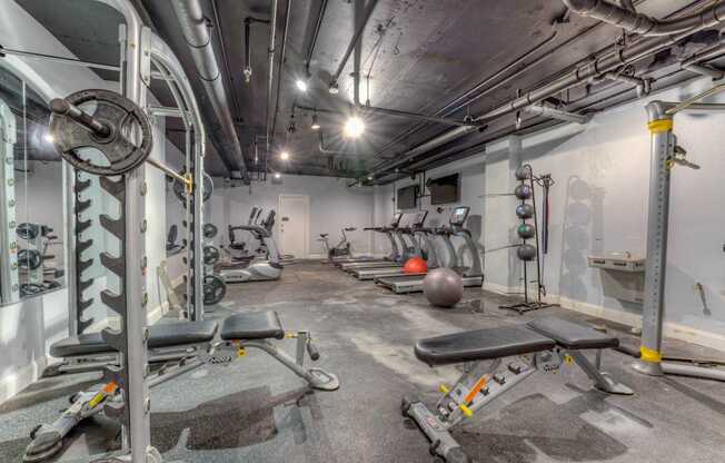 A gym with a variety of equipment including weights and benches.at Iris Luxury Apartments, Memphis Tennessee