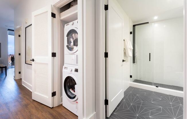 a bathroom with a washer and dryer in a closet at The Irvine, Philadelphia