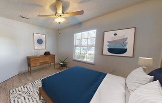 a bedroom with a bed and a ceiling fan