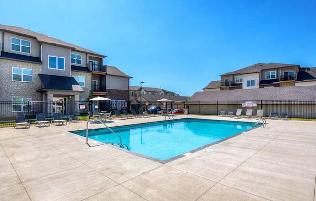 our apartments offer a swimming pool with a building in the background