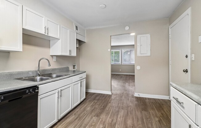 Elevate your lifestyle at The Preserve On Conley Apartments. This modern kitchen features sleek appliances and wood-style flooring, creating a warm and inviting atmosphere. Don't miss your chance—schedule a tour today!
