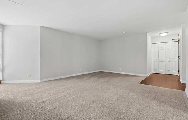 A room with a carpeted floor and white walls.