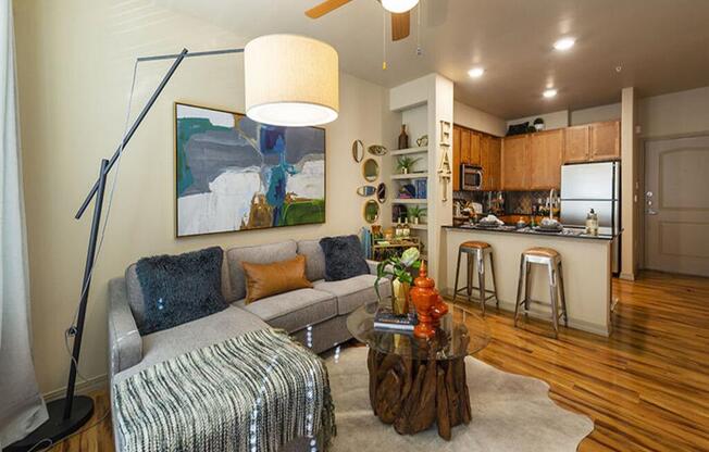 a living room filled with furniture and a ceiling fan