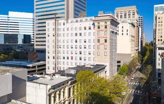 an aerial view of a white building in the city