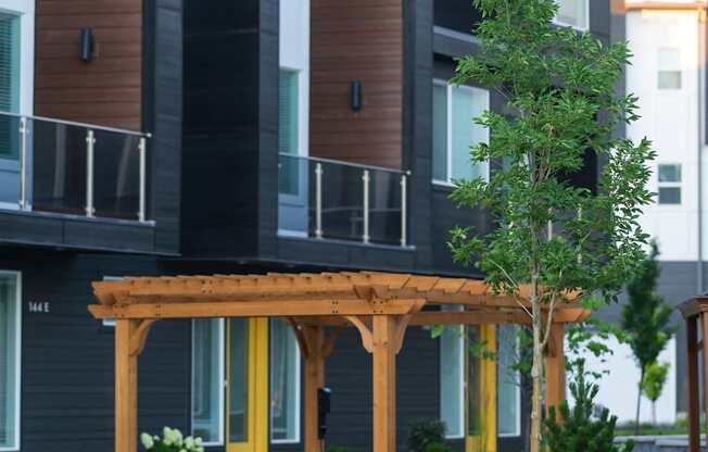 A modern house with a balcony and a tree.