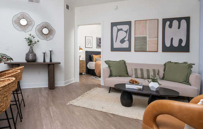 A living room with a couch, a table, and a chair.