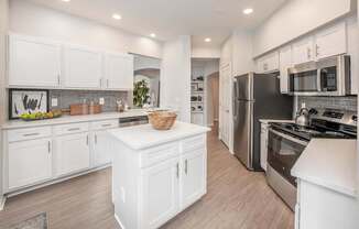 a large kitchen with white cabinets and stainless steel appliances, Henley Tampa Palms, Tampa, FL