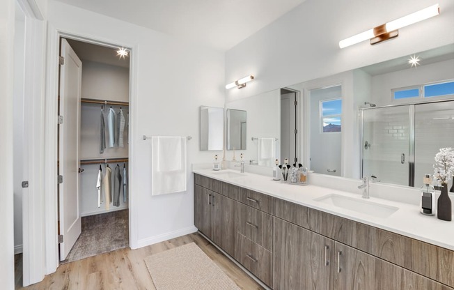 a bathroom with two sinks and a shower and a mirror