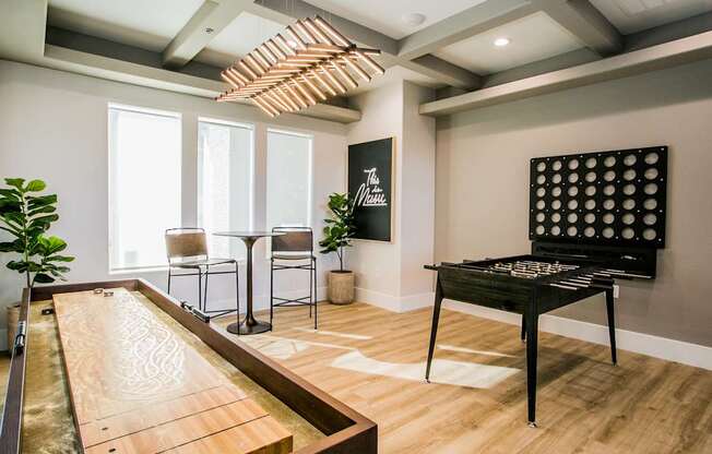 A shiny pool table is in the middle of a room with a billiard table.