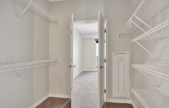 a walk in closet at the enclave at woodbridge apartments in sugar land, tx