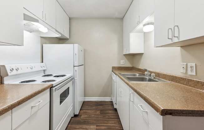 a kitchen with white appliances and white cabinets