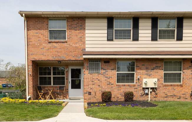 A house with a red brick facade and a white door.