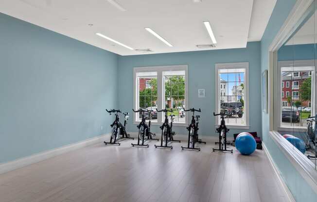 an exercise room with bikes and an exercise ball