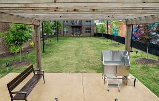 a backyard with a grill and a picnic table