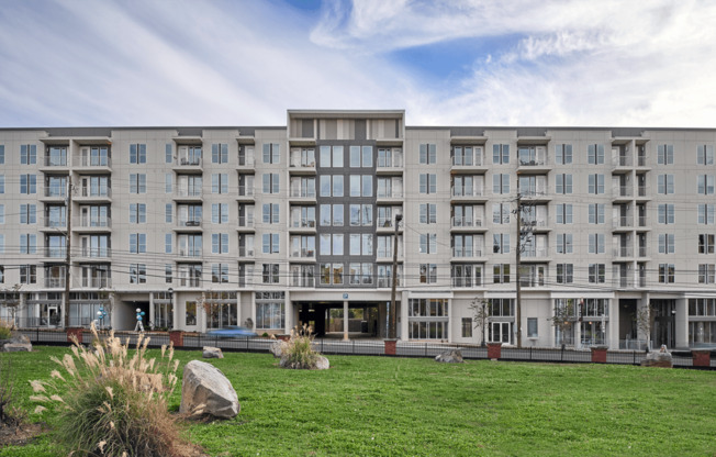 a large apartment building with a grassy area in front of it at Link Apartments® Canvas, Georgia