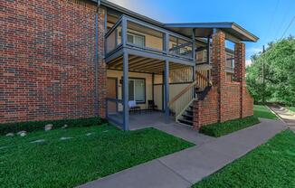 a large lawn in front of a brick building