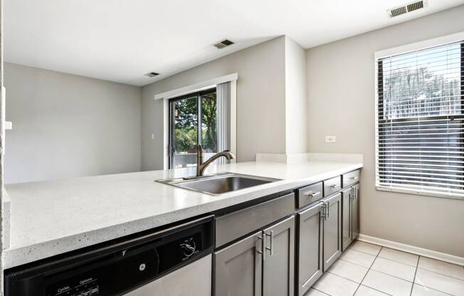 an empty kitchen with a sink and a window