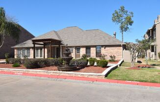 this is a photo of a house with a fountain in the front yard