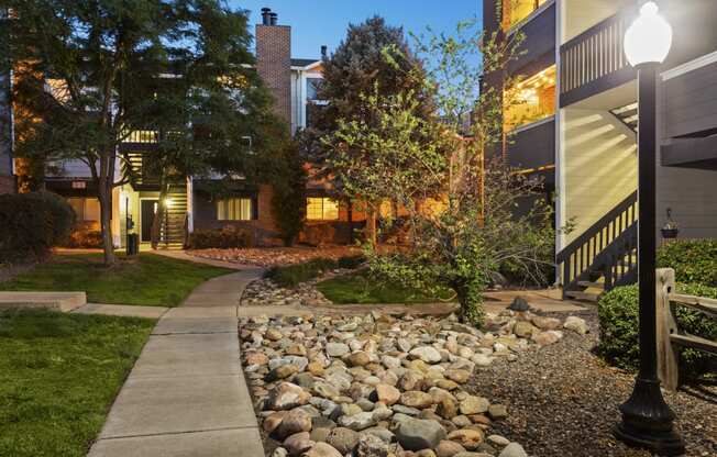 a walkway with a sidewalk and rocks in front of a house at Verona, Littleton, CO